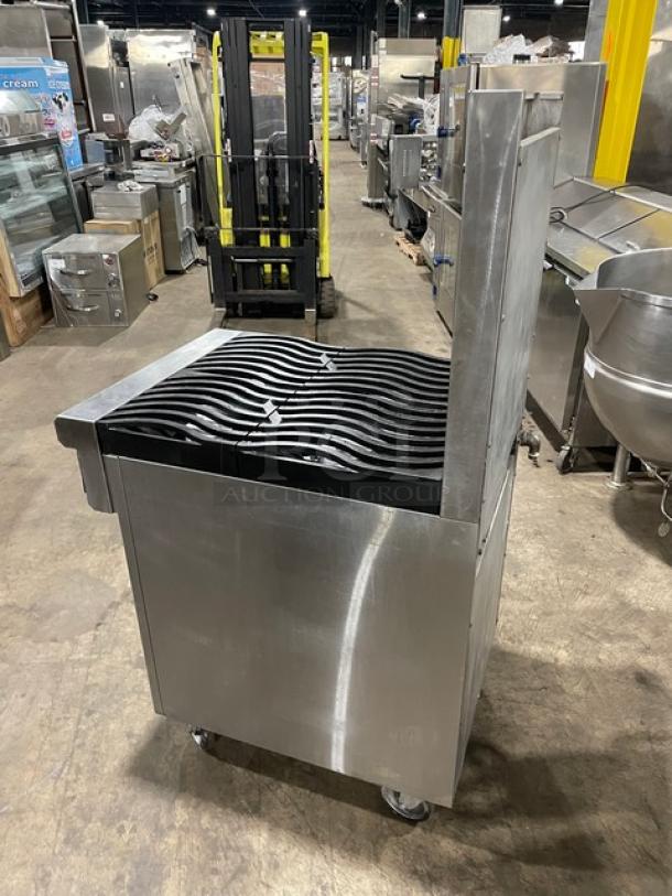 Commercial stainless steel charbroiler with cast iron grates, mobile on casters, in used condition, ideal for restaurant use.