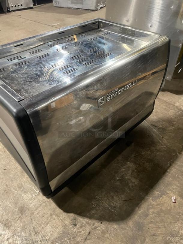 Nuova Simonelli espresso machine, stainless steel, slight surface scratches, model unknown, for commercial use.