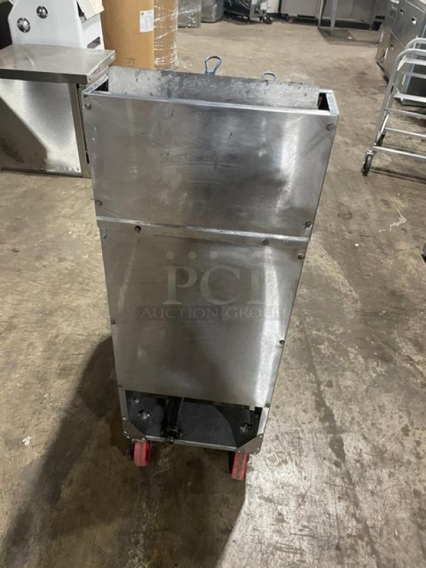 Stainless steel commercial cart with red wheels, showing signs of use. Ideal for industrial or kitchen settings.