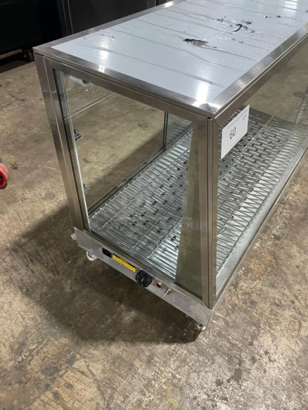 Stainless steel commercial display warmer with glass panels, adjustable shelves, and temperature control. Marked with auction number 60.