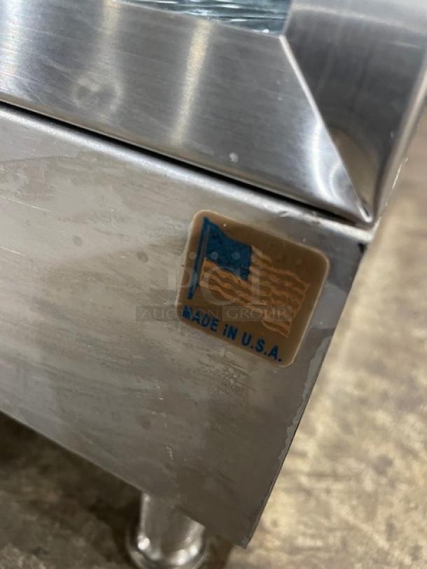 Stainless steel appliance corner with a "Made in U.S.A." label. Condition appears slightly worn.