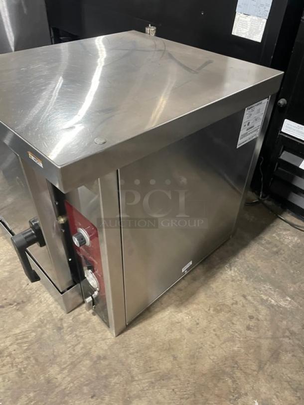 Commercial stainless steel warming cabinet with temperature dials, venting, and visible serial label. Good condition.