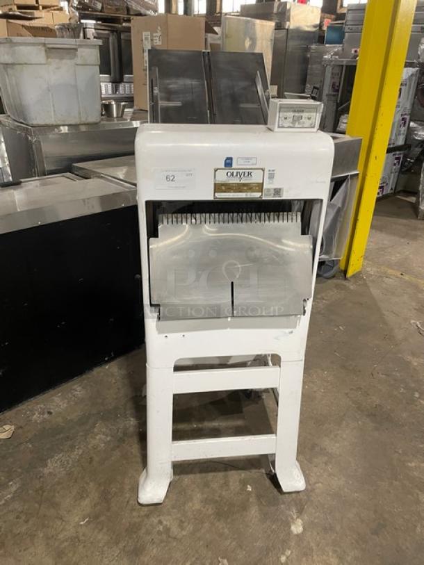 Oliver bread slicer, model 62, in white, with stainless steel blades. Used condition, features control panel and brand label.