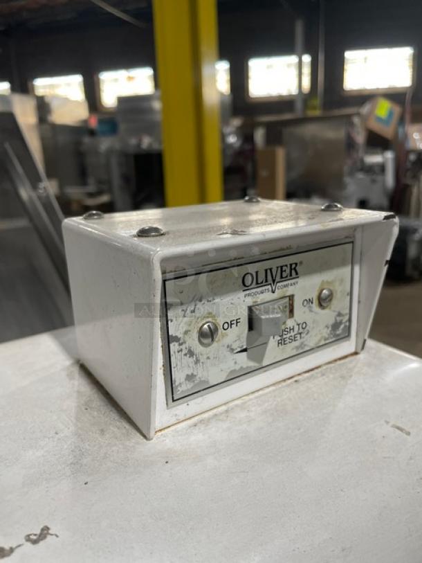 White Oliver Products control box with on/off switch, labeled "PUSH TO RESET," shows slight wear.