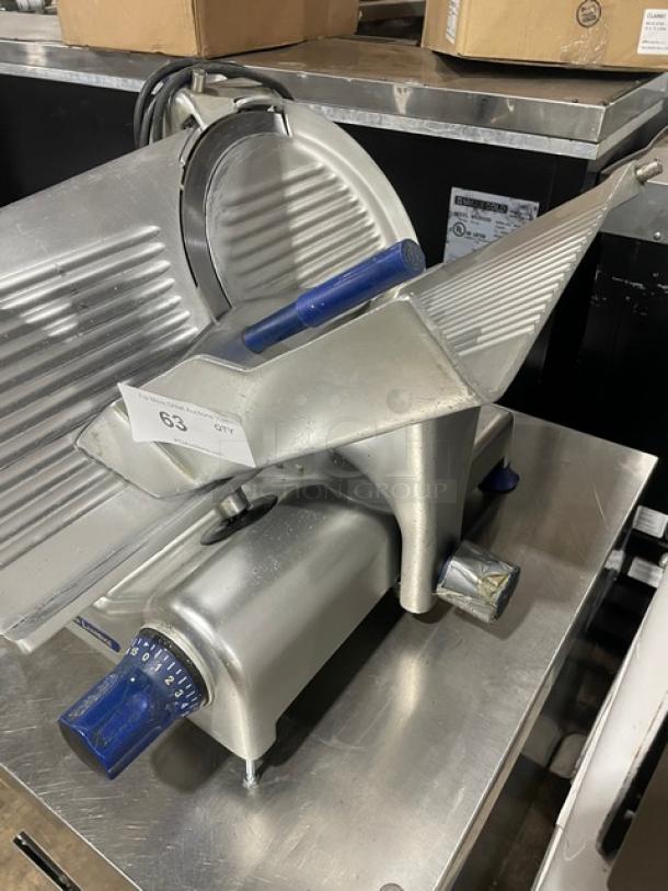 Commercial deli meat slicer with adjustable settings, stainless steel, used condition, labeled "63 QTY," visible wear.