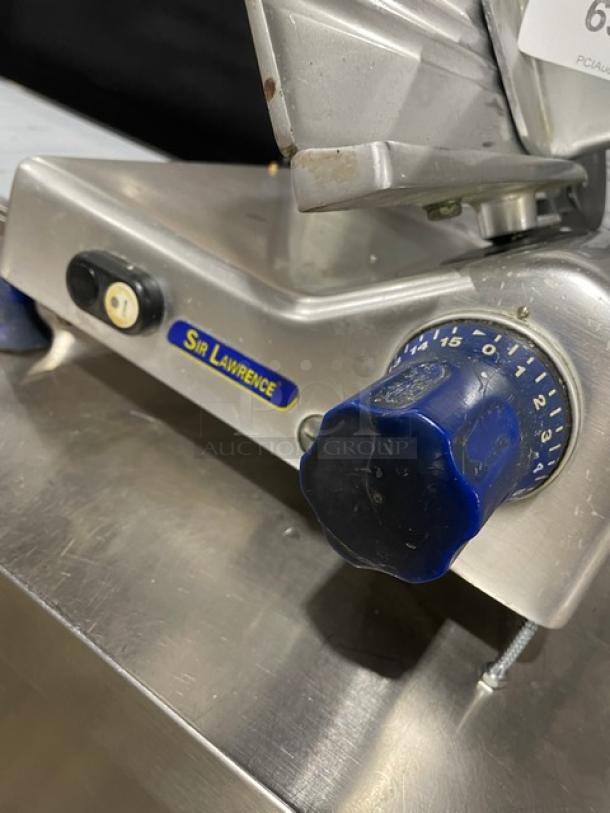 Industrial meat slicer, Sir Lawrence brand, blue dial settings 0-15, silver metal body, used condition.