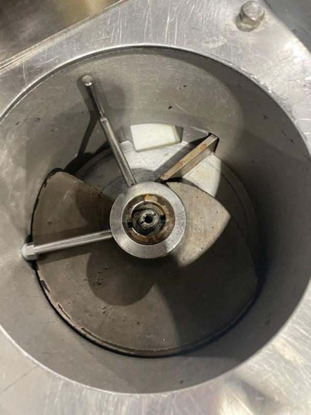Industrial stainless steel blade mechanism with central hub, used, in good condition. Ideal for manufacturing equipment.