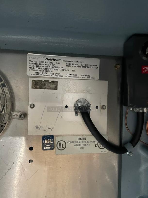 Delfield commercial refrigerator model 406CA label; NSF and UL listed; electrical specs and serial number visible.