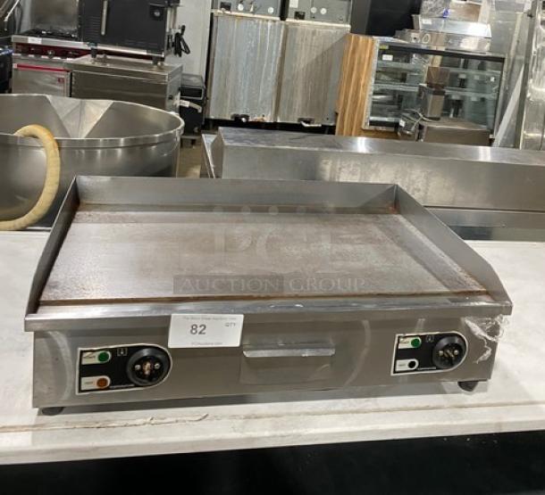 Commercial stainless steel electric countertop flat griddle with back and side splash, on legs, dual control knobs.