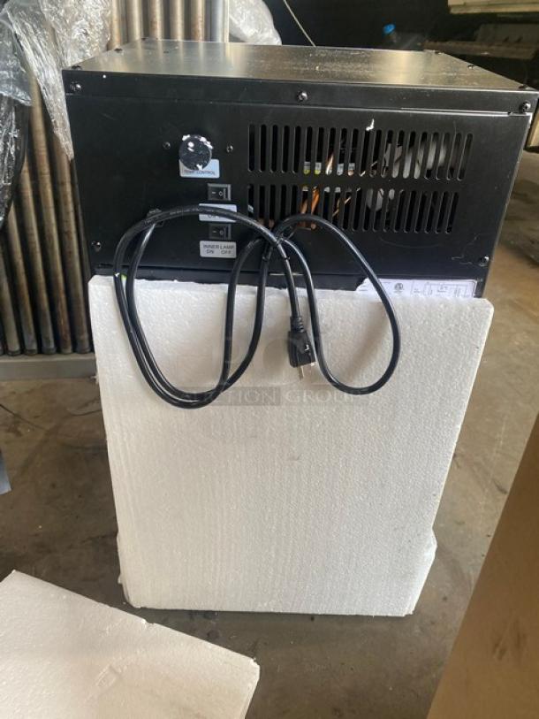 Nordon G-10A commercial display cooler back view. Features cooling vents, power cord, black finish, scratch-n-dent condition.