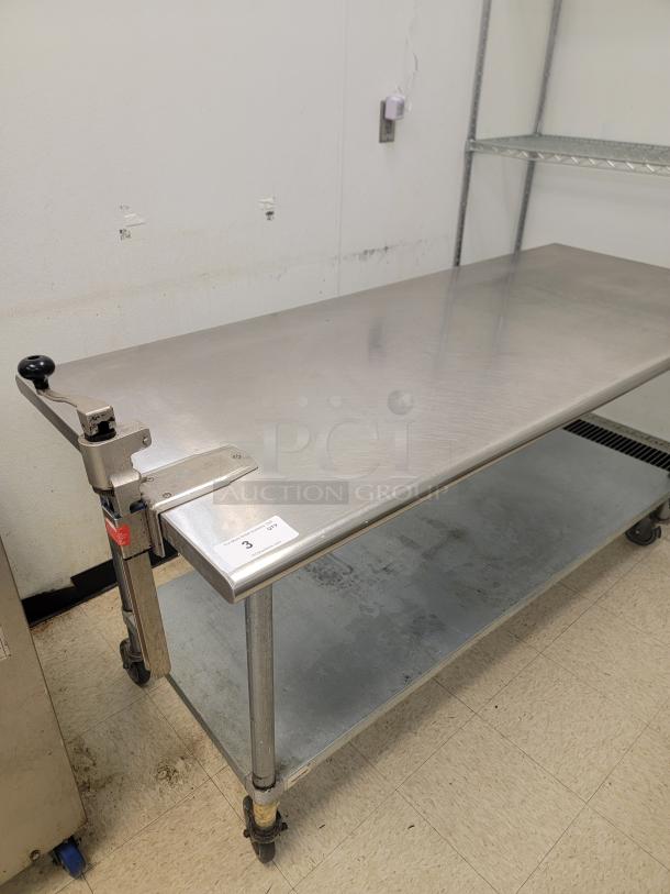 6' Stainless Worktable with Edlund Can Opener! Tired of clutter and slow prep times in your commercial kitchen? Upgrade your workspace with this versatile 6-foot Stainless Steel Worktable on Casters, complete with an attached Commercial Edlund Can Opener! *BUYER MUST REMOVE - NO SHIPPING OR HANDLING AVAILABLE* - Image 1 of 2