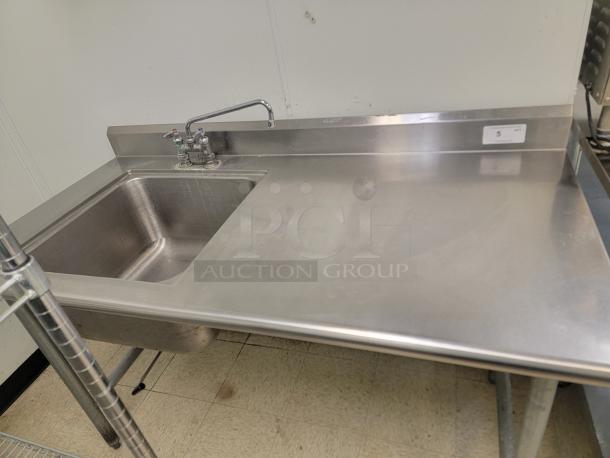 5' Stainless Workstation w/ Sink & Faucets! Looking to upgrade your prep area or add a dedicated wash station? This 5-foot Stainless Steel Workstation is a fantastic find, combining ample counter space with a built-in sink, making it incredibly versatile for a variety of settings! *BUYER MUST REMOVE - NO SHIPPING OR HANDLING AVAILABLE* - Image 1 of 4