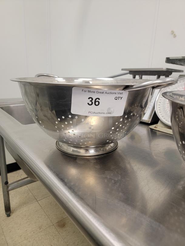 (2) 14" Stainless Steel Colanders - Essential Kitchen Tools! Upgrade your kitchen with these versatile and durable colanders, perfect for draining pasta, rinsing fruits and vegetables, straining stocks, and much more. An indispensable item for any home cook or commercial kitchen! *BUYER MUST REMOVE - NO SHIPPING OR HANDLING AVAILABLE* - Image 2 of 2