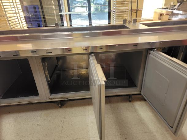 Randell 18-Foot Refrigerated Prep Table with Cold Food Wells - Massive Capacity! Revolutionize your kitchen's prep and cold storage! We're offering an impressive 18-foot Randell Refrigerated Prep Table with integrated Cold Food Wells, the ultimate solution for high-volume sandwich, salad, pizza, or assembly lines. This is a must-have for large restaurants, delis, catering operations, or institutional kitchens that demand efficiency and ample refrigerated storage. *BUYER MUST REMOVE - NO SHIPPING OR HANDLING AVAILABLE* - Image 4 of 15