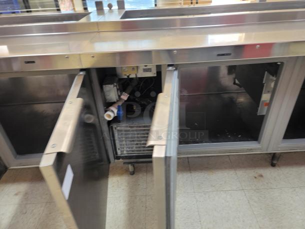Randell 18-Foot Refrigerated Prep Table with Cold Food Wells - Massive Capacity! Revolutionize your kitchen's prep and cold storage! We're offering an impressive 18-foot Randell Refrigerated Prep Table with integrated Cold Food Wells, the ultimate solution for high-volume sandwich, salad, pizza, or assembly lines. This is a must-have for large restaurants, delis, catering operations, or institutional kitchens that demand efficiency and ample refrigerated storage. *BUYER MUST REMOVE - NO SHIPPING OR HANDLING AVAILABLE* - Image 5 of 15