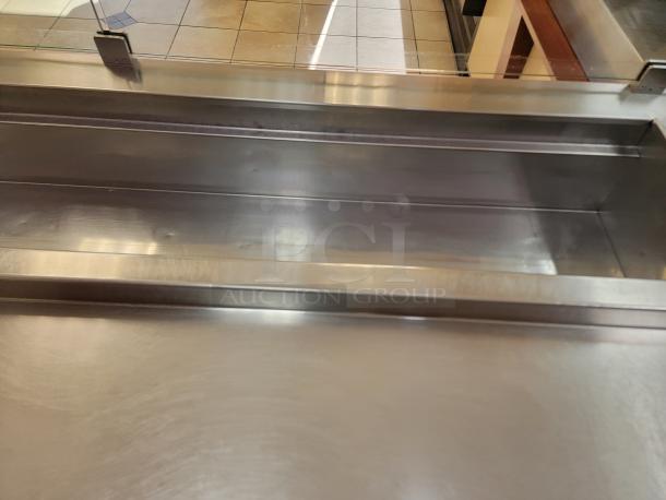 Randell 18-Foot Refrigerated Prep Table with Cold Food Wells - Massive Capacity! Revolutionize your kitchen's prep and cold storage! We're offering an impressive 18-foot Randell Refrigerated Prep Table with integrated Cold Food Wells, the ultimate solution for high-volume sandwich, salad, pizza, or assembly lines. This is a must-have for large restaurants, delis, catering operations, or institutional kitchens that demand efficiency and ample refrigerated storage. *BUYER MUST REMOVE - NO SHIPPING OR HANDLING AVAILABLE* - Image 7 of 15