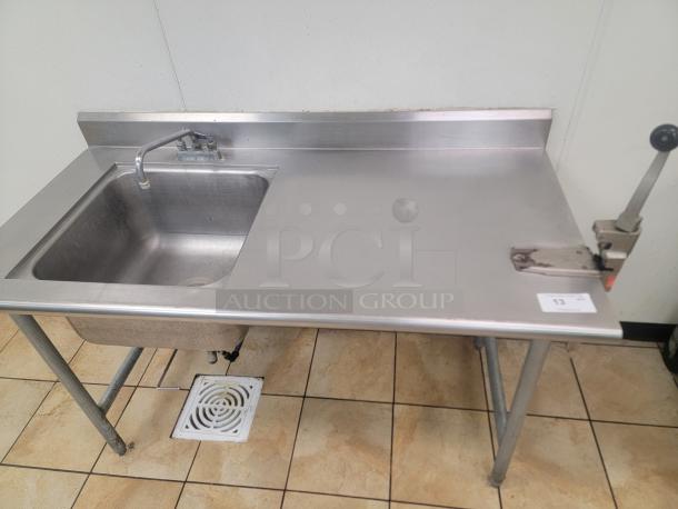 Elevate Your Workspace with this Durable Stainless Steel Sink Unit! 5' Stainless Worktable/Sink with Edlund Can Opener & spare! Tired of clutter and slow prep times in your commercial kitchen? Upgrade your workspace with this versatile 5-foot Stainless Steel Worktable, complete with an attached Commercial Edlund Can Opener and 20'x20"x12" sink! *BUYER MUST REMOVE - NO SHIPPING OR HANDLING AVAILABLE* - Image 1 of 3