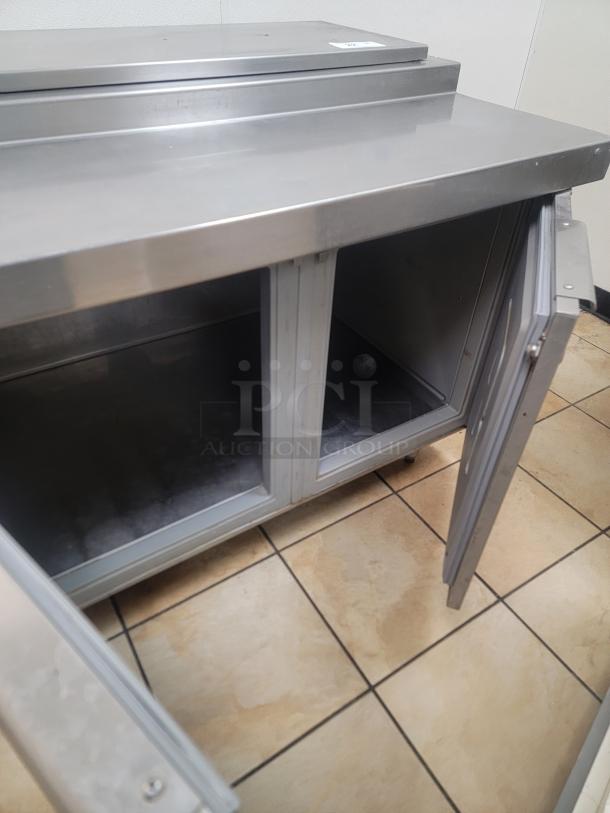 Randell 84111N-290 111" Pizza Prep Table w/ Refrigerated Base, 115v! Elevate your pizzeria's efficiency and product freshness with this massive pizza prep table! Designed for high-volume operations, this 111-inch workhorse provides ample space for preparing multiple pizzas simultaneously while keeping all your ingredients perfectly chilled and accessible. *BUYER MUST REMOVE - NO SHIPPING OR HANDLING AVAILABLE* - Image 4 of 6