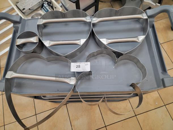 Commercial-grade dough cutters set: 3 large heart (12"), 1 shamrock (12"), 1 round (5"). Durable, perfect for themed baking.