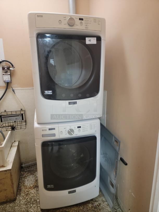 Maytag Electric Stackable Washer & Dryer Set - Efficient & Space-Saving! Fantastic Maytag electric stackable washer and dryer set, perfect for maximizing space in your laundry area! This reliable duo offers powerful cleaning and drying performance in a compact footprint. *BUYER MUST REMOVE - NO SHIPPING OR HANDLING AVAILABLE* - Image 1 of 7