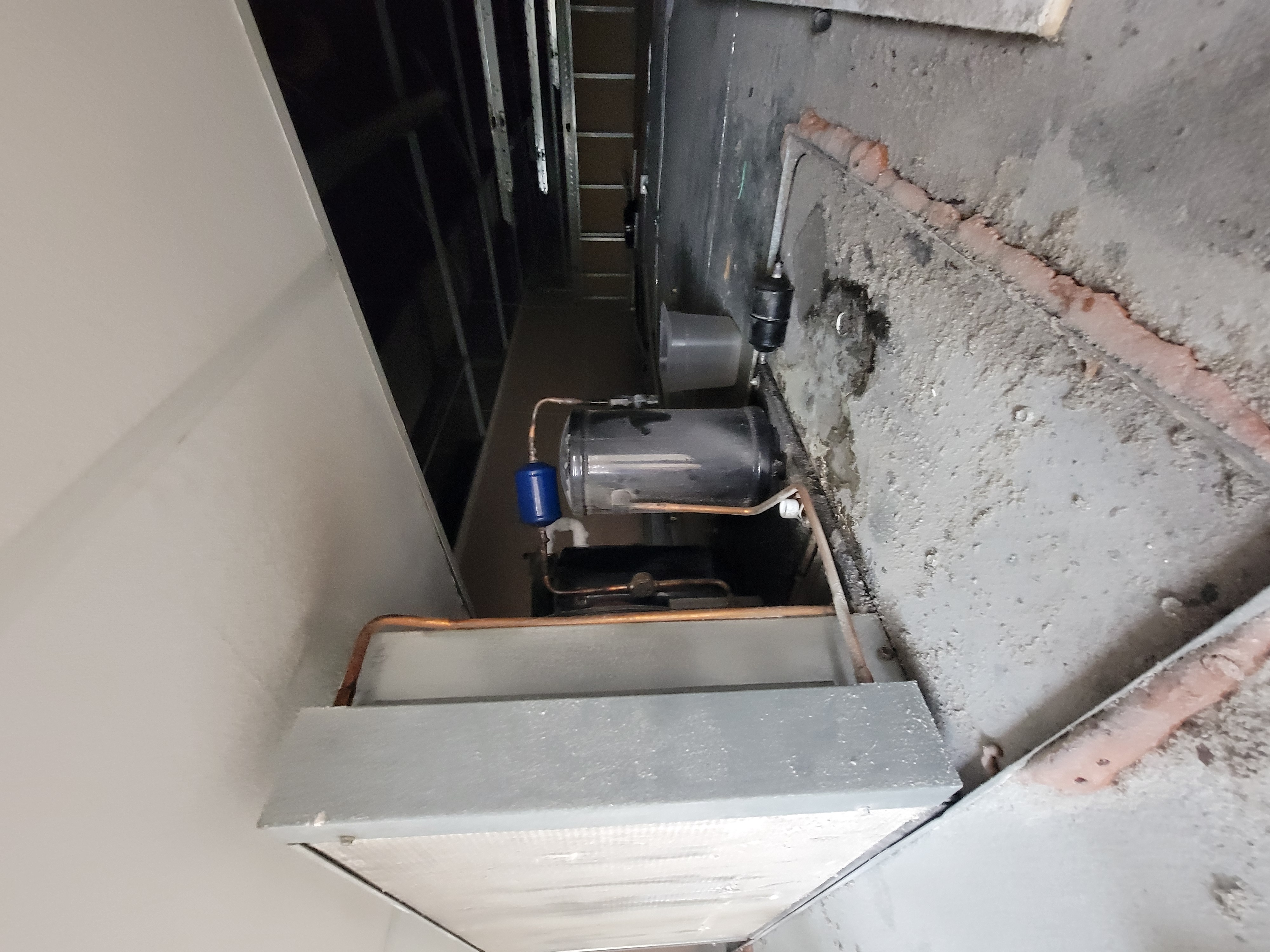 Walk-in cooler condenser unit showing reasonable cleanliness