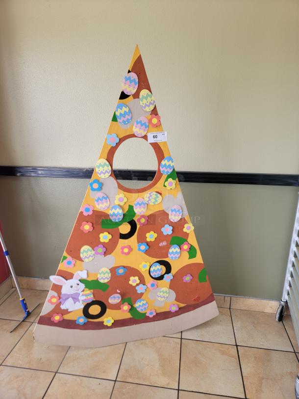Giant Pizza Slice Photo Booth Prop / Selfie Frame - Easter/Spring Theme! The large cutout in the center of the "pizza slice" allows individuals to stand behind it and place their faces within the opening, creating a fun photo opportunity, similar to a selfie frame or a photo booth prop. *BUYER MUST REMOVE - NO SHIPPING OR HANDLING AVAILABLE* - Image 1 of 2