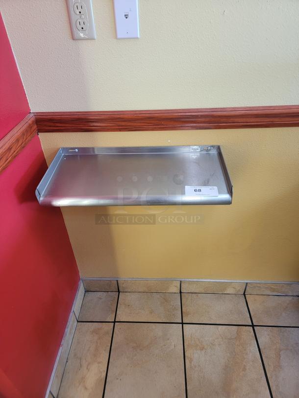 Advance Tabco WS-KD-24 stainless steel wall shelf, 2-foot, sturdy, ideal for kitchens, visible label "68," installed on wall.