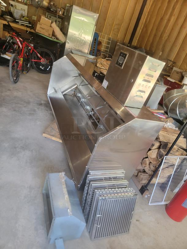 Large industrial stainless steel rotisserie oven with multiple removable grates and control panel. Good condition.