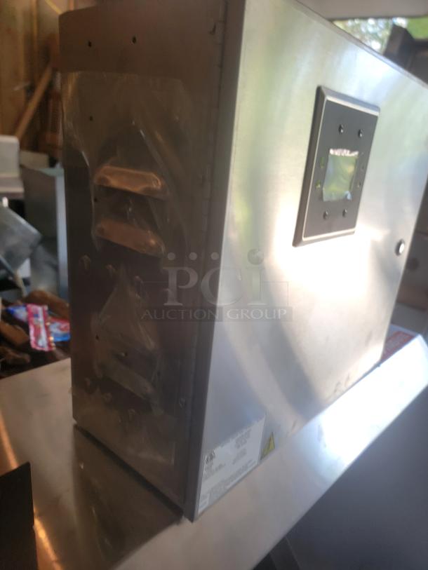 Stainless steel commercial toaster, side view, shows control panel and serial tag. Light wear, no visible damage.