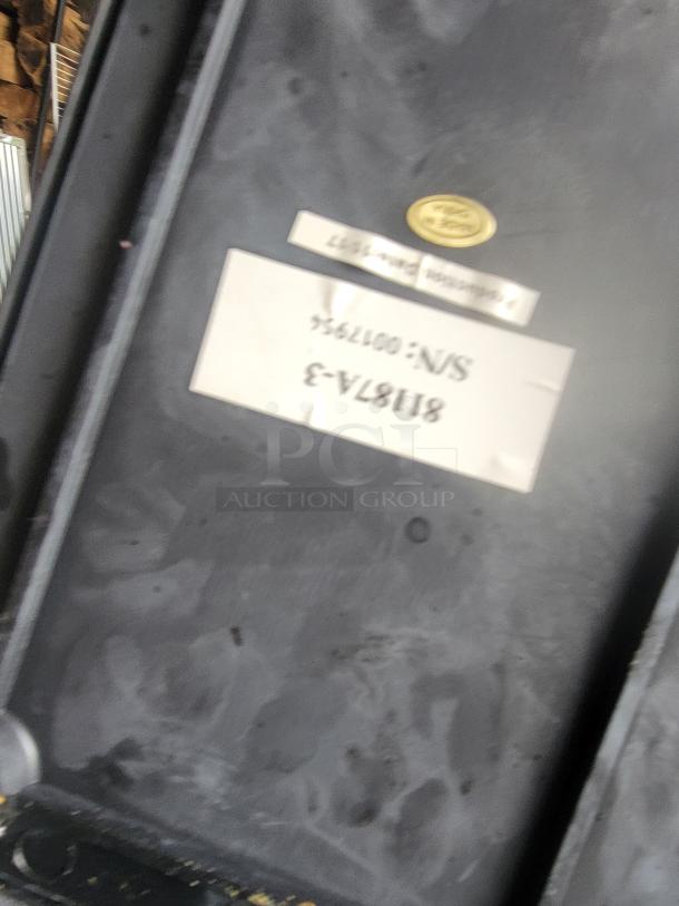 Black industrial case with a label reading "81187A-3 S/N: 0017956," and a gold oval emblem in good condition.