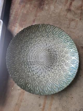 Ornate round glass plate with iridescent finish and intricate peacock feather pattern; excellent condition.