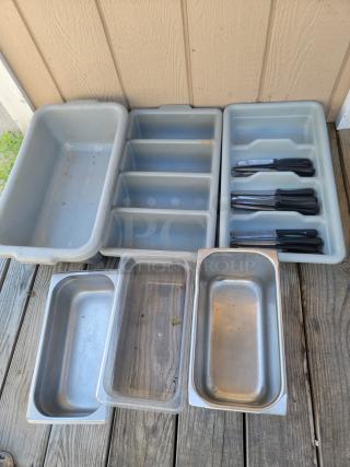 Versatile commercial kitchen organization set, includes used trays, utensil holders, and silverware. Ideal for catering or home use.