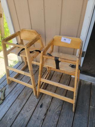 Two sturdy wooden restaurant high chairs with straps, showing light wear, ideal for family dining venues.