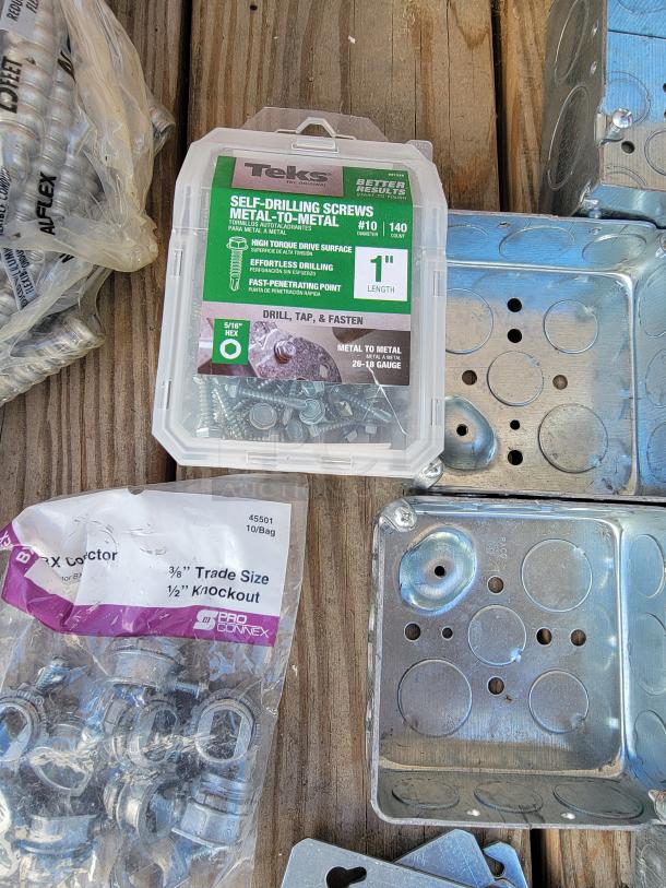 Assorted electrical supplies including Teks self-drilling screws, metal junction boxes, and ProConnex connectors.