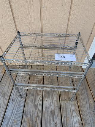 Versatile 3-tier chrome steel utility rack in good condition, ideal for storage. Includes visible auction number tag.