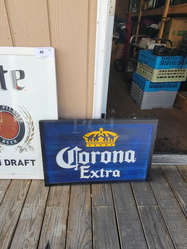 Miller Lite "On Draft" mirror sign with "A Fine Pilsner Beer" crest, framed for display; Corona Extra wooden sign with rustic charm.