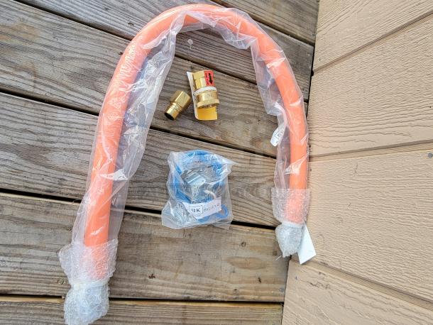 BK Resources Gas Hose Connection Kit, model 3/4 x 48", includes orange hose and fittings, sealed packaging, ideal for kitchens.