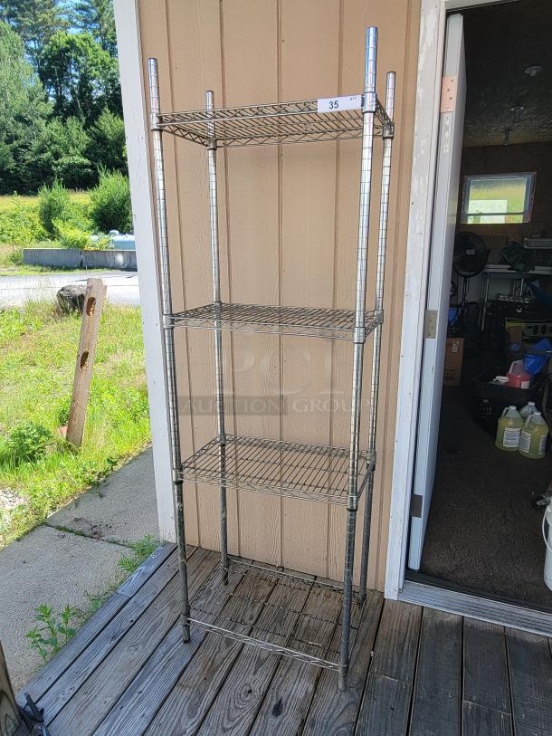 Versatile 2' x 14" x 6' NSF chrome wire shelving unit with three shelves, ideal for storage. Sturdy and in good condition.