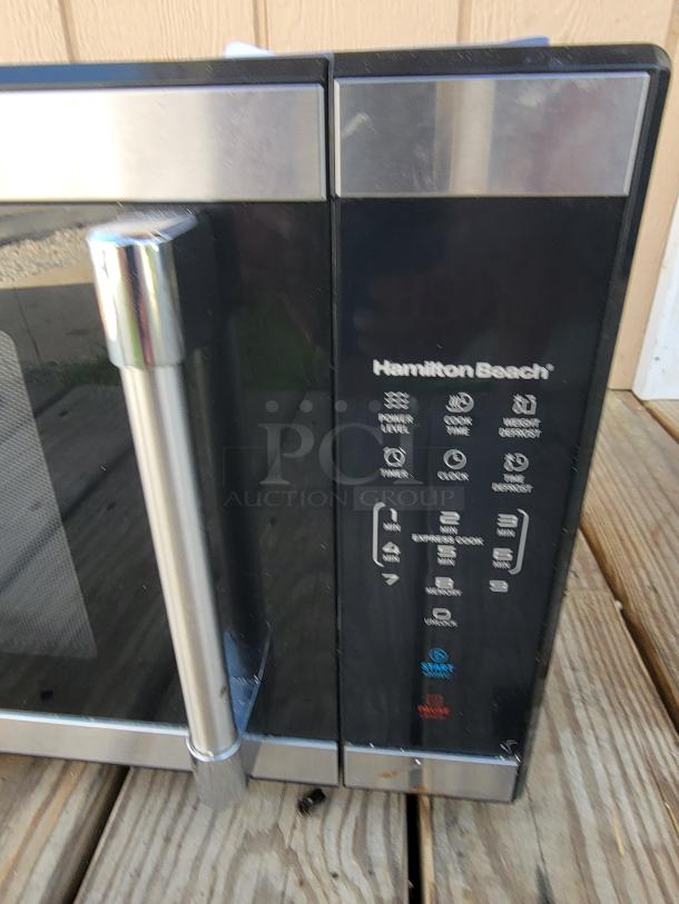Hamilton Beach 1.1 cu. ft. countertop microwave with stainless steel handle and digital controls, in good condition.
