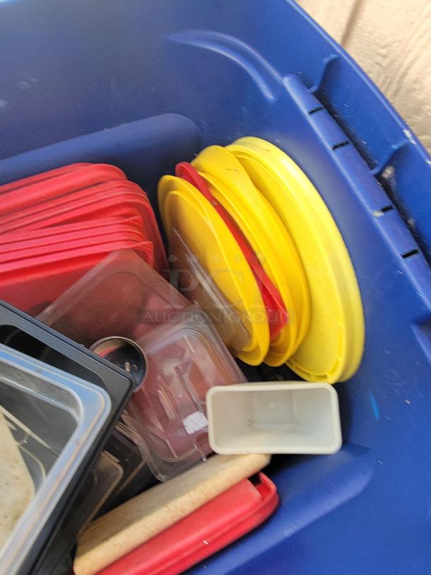 Assorted durable plastic and metal kitchen storage containers and lids in various sizes, ideal for commercial and home use.