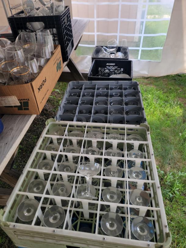 Huge assorted glassware lot in crates; variety of glass types for collection, kitchen use, crafts, or decor. Excellent condition.