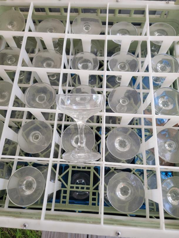 Assorted glassware lot in a compartmentalized tray, ideal for collections, decor, or crafts; includes various glass styles.