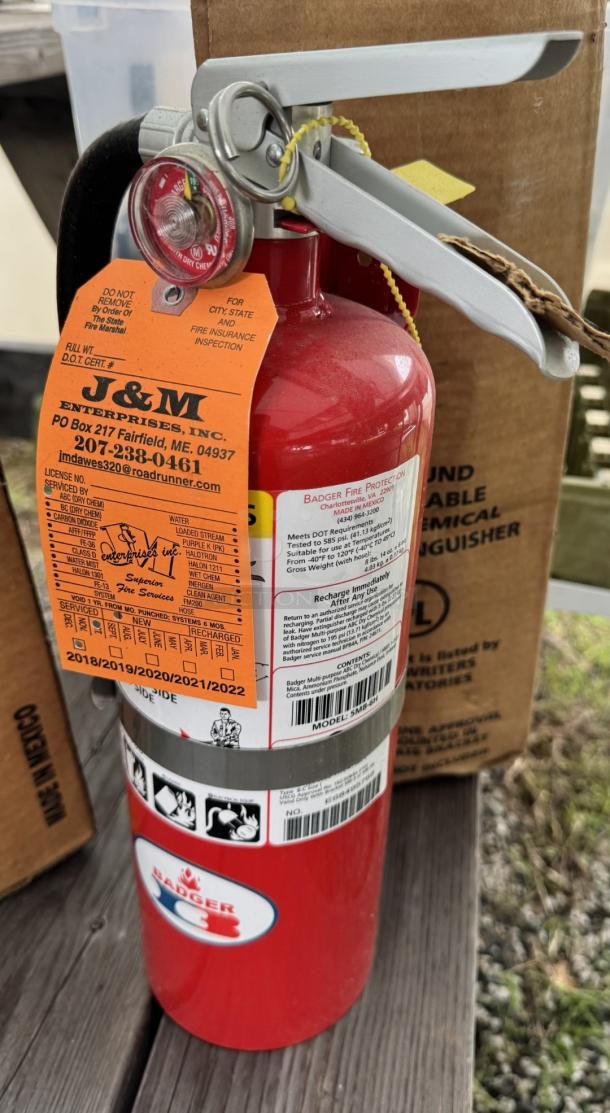Badger 5MB-6H ABC fire extinguisher, new in box, with tags and labels, featuring a dry chemical for multi-purpose use.