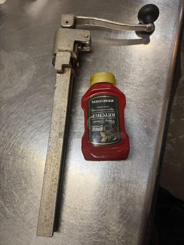 Heavy-duty commercial can opener with robust construction, designed for large cans. Ideal for restaurants and kitchens.
