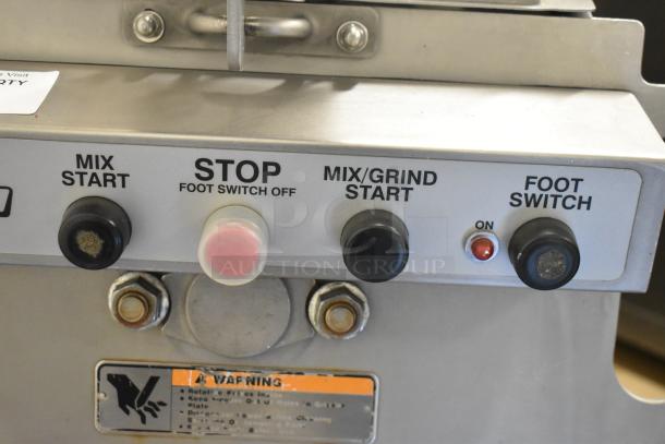 Hobart MG2032 meat grinder control panel with mix, stop, mix/grind, and foot switch buttons. Warning label visible.