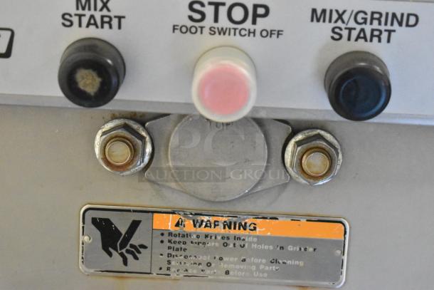 Hobart MG2032 meat mixer grinder controls; features start/stop buttons, foot pedal, warning label. Electric, 208V, 3 phase.
