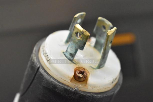 Close-up of a 208V, 3-phase plug for a Hobart MG2032 meat mixer grinder, showing slightly tarnished metal prongs.