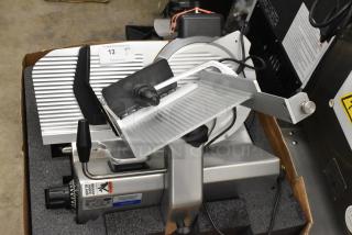 Brand new Globe SG13A-24 automatic meat slicer with 13" blade, built-in sharpener; slight scratches; 110V, 1 Phase.