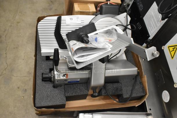 Brand new Globe SG13A-24 commercial meat slicer with 13" blade and sharpener, shown with packaging and documents. 110 volts, 1 phase.