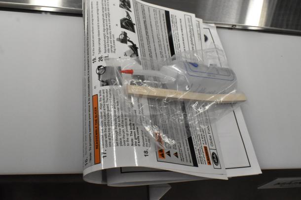 Brand new Globe SG13A-24 automatic slicer with manual, still in packaging; includes a 13" blade and blade sharpener.